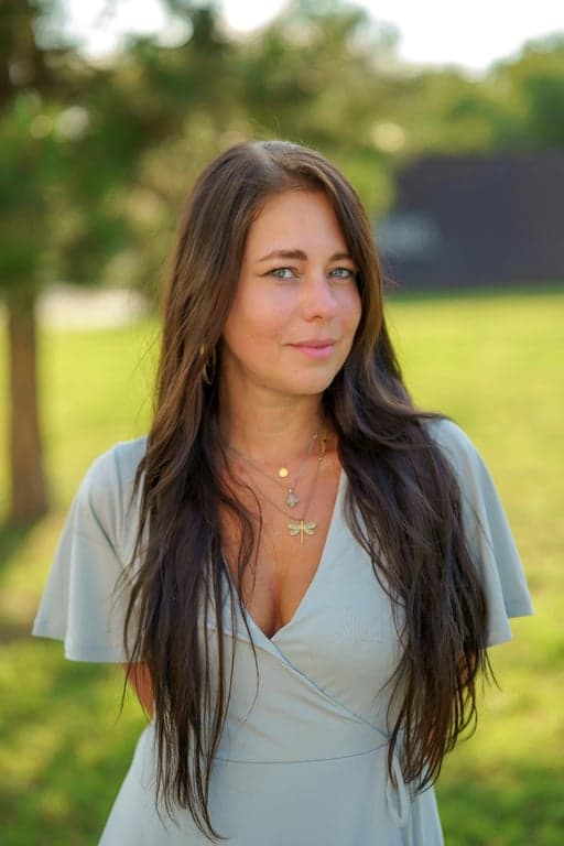 a portrait of a person enhanced with sunset lighting effects, including soft rim light, warm skin tones, and subtle atmospheric glow