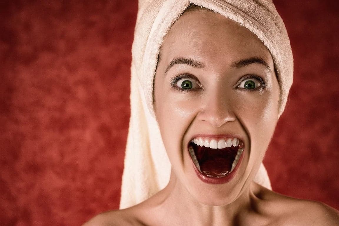 AI teeth whitening filter after photo - woman with red background smiling with bright white teeth