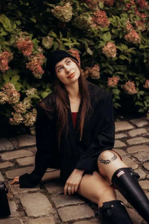 transform the image into a dating app photo by improving lighting direction, clarifying facial features, refining jaw and cheek contours in a noticeable but believable way, enhancing eye focus, simplifying background clutter, preserving identity and skin texture, and presenting the subject with a confident approachable expression that reads as authentic and clearly improved from the original