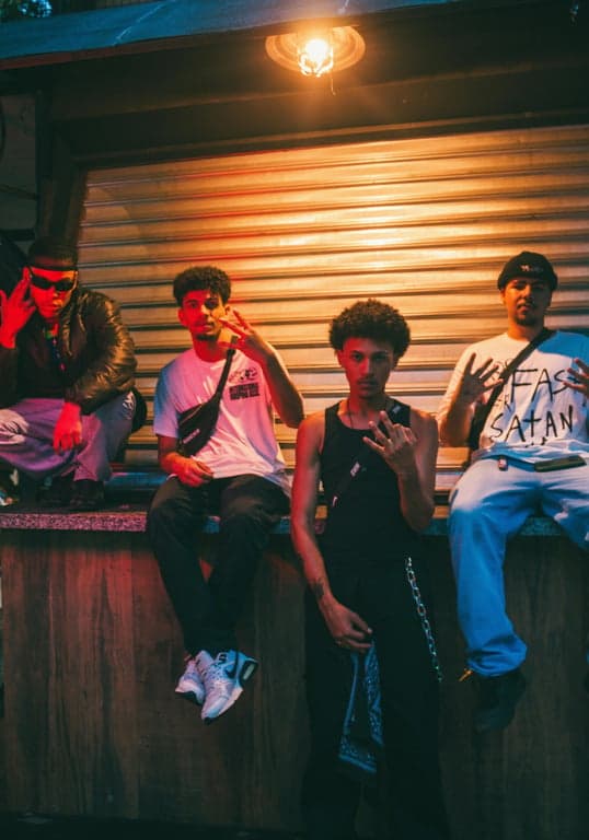 a portrait of multiple men styled with expressive K-pop boy group fashion elements, statement jackets, layered textures, clear styling logic, confident stance, and balanced lighting