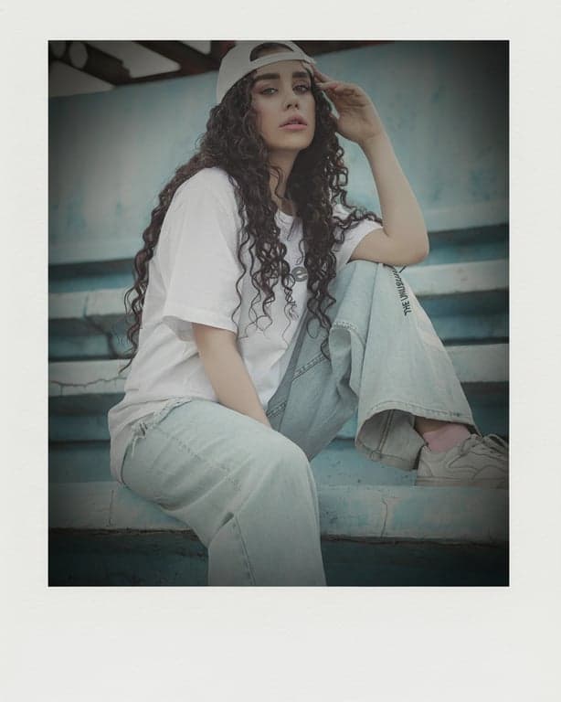 a portrait of a person transformed into a Polaroid-style instant photo with smooth tones, gentle haze, soft contrast, and subtle vignette