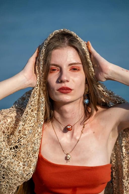 Expand the existing image of the woman into a complete full-body view without changing the outfit, environment, or visual style. Accurately infer leg length, stance, and body balance based on the visible upper body, ensuring natural proportions, stable footing, and smooth transitions between the original image and the reconstructed areas.