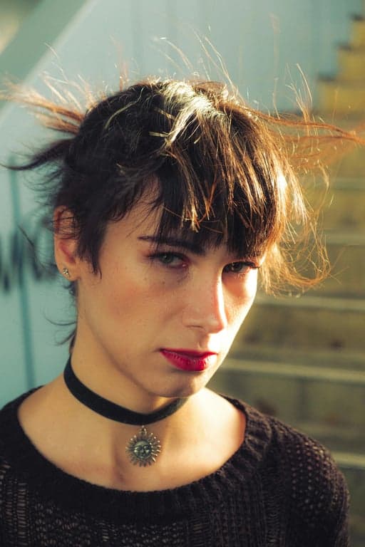 a portrait of a person styled with a casual aesthetic outfit look, soft tones, coordinated clothing impression, relaxed posture, even lighting, and minimal background