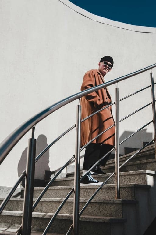 a portrait of a person styled as a classic shonen anime character, wearing simple fitted anime clothing, bold color contrasts, clean silhouette, expressive eyes, and dramatic yet clean anime shading