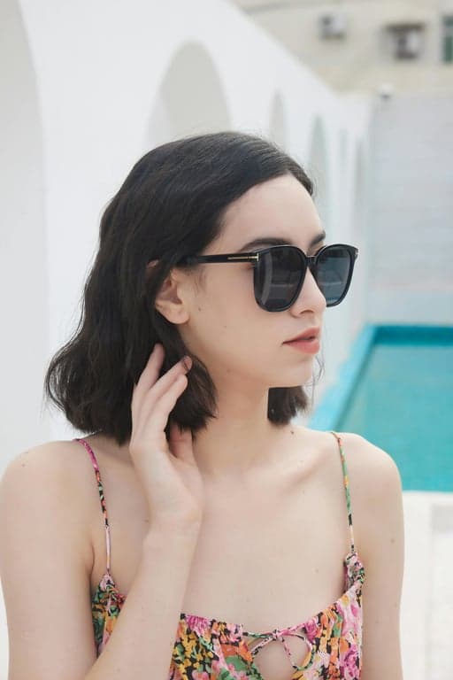 Complete the person’s full body by extending downward from the original image, maintaining the existing fashion style, clothing design, and visual tone. Preserve the original silhouette and posture logic, and reconstruct the lower body with confident stance, realistic proportions, and seamless continuity without changing the background or outfit.