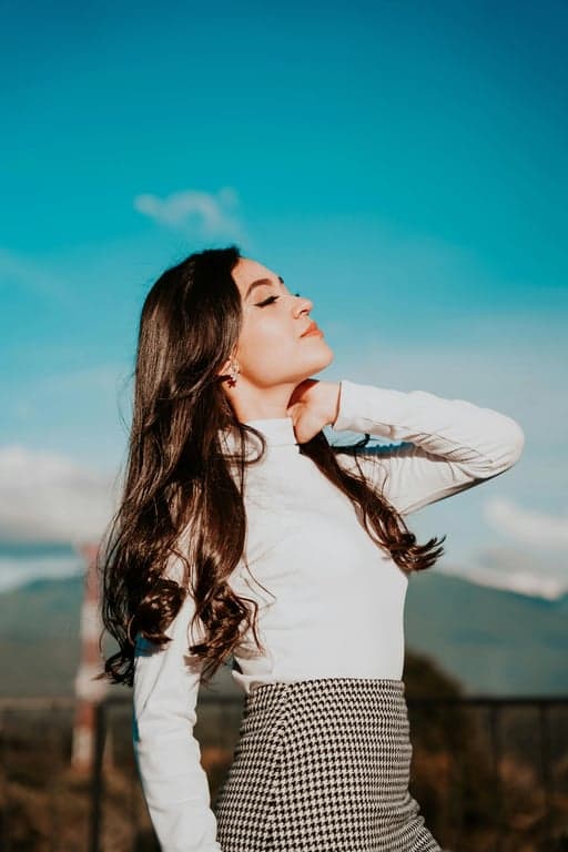 a portrait of a person edited to boost hair volume only, enhancing thickness through strand-level density rather than reshaping; maintain original hairstyle direction and length; keep hairline natural; avoid artificial shine or blur; do not modify facial identity, body posture, or background; output should look like a realistic volume enhancement