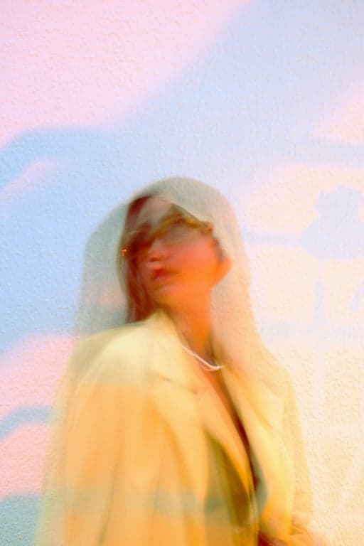 a portrait of a person with chaotic lens flare artifacts selectively removed, preserving the original face lighting and natural light direction, while eliminating random glare spots, streaks, and visual noise that reduce facial clarity