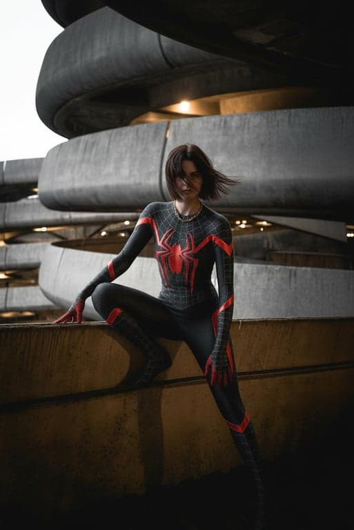 a portrait of a person transformed into a spider hero with cinematic comic lighting, bold color contrast, and a powerful heroic stance