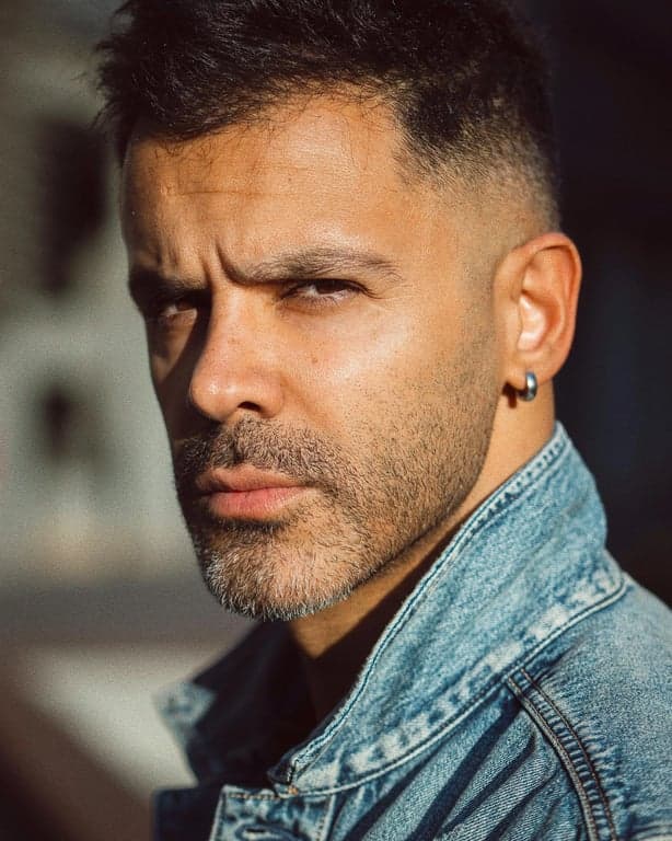 Extend the original image into a full-body composition designed for general use by filling in only the missing body areas. Maintain the same silhouette, pose mechanics, clothing style, and scene context so the completed figure feels structurally coherent and visually balanced.