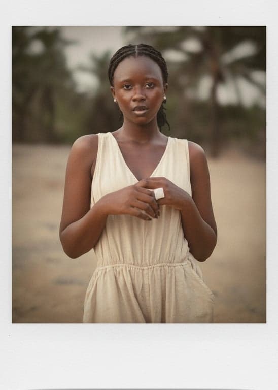 a portrait of a person enhanced with a Polaroid instant photo look, featuring soft contrast, slightly faded colors, warm highlights, gentle haze, subtle vignetting, and clean instant-film texture
