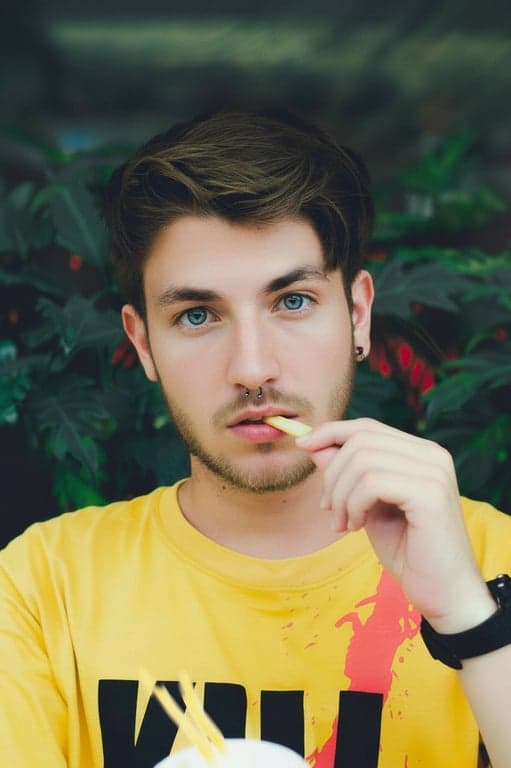 a portrait of a man, realistic photo editing, natural skin texture enhancement, subtle color correction, professional retouching, clean background.