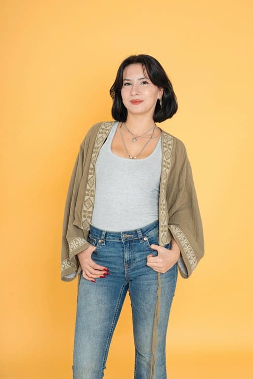 a portrait of a woman with detailed cornrow braids, realistic hair texture, beads at the ends, professional styling, studio lighting.