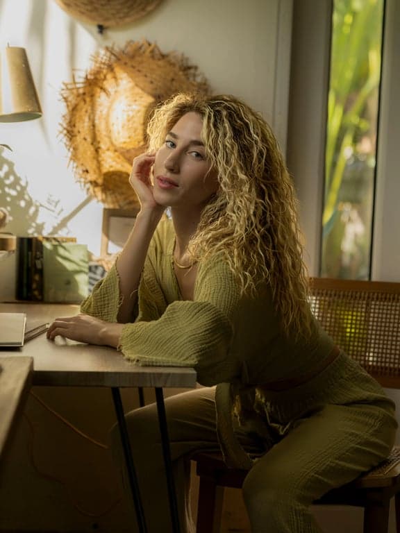 AI ugly filter before photo- woman with golden hair sitting and looking sideways