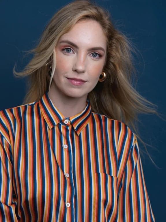 a portrait of a person edited so the hairline is clearly repositioned lower on the forehead, resulting in a visibly fuller hairline and a face that appears smaller and more proportionate