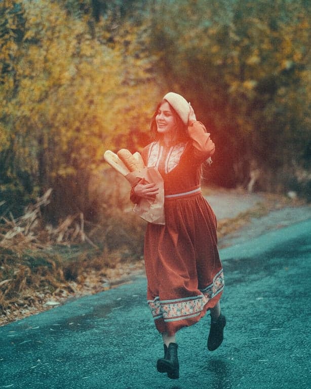 A street scene transformed with an 80s film look, featuring strong grain structure, cyan shadows, and the halation effect typical of older film stocks.