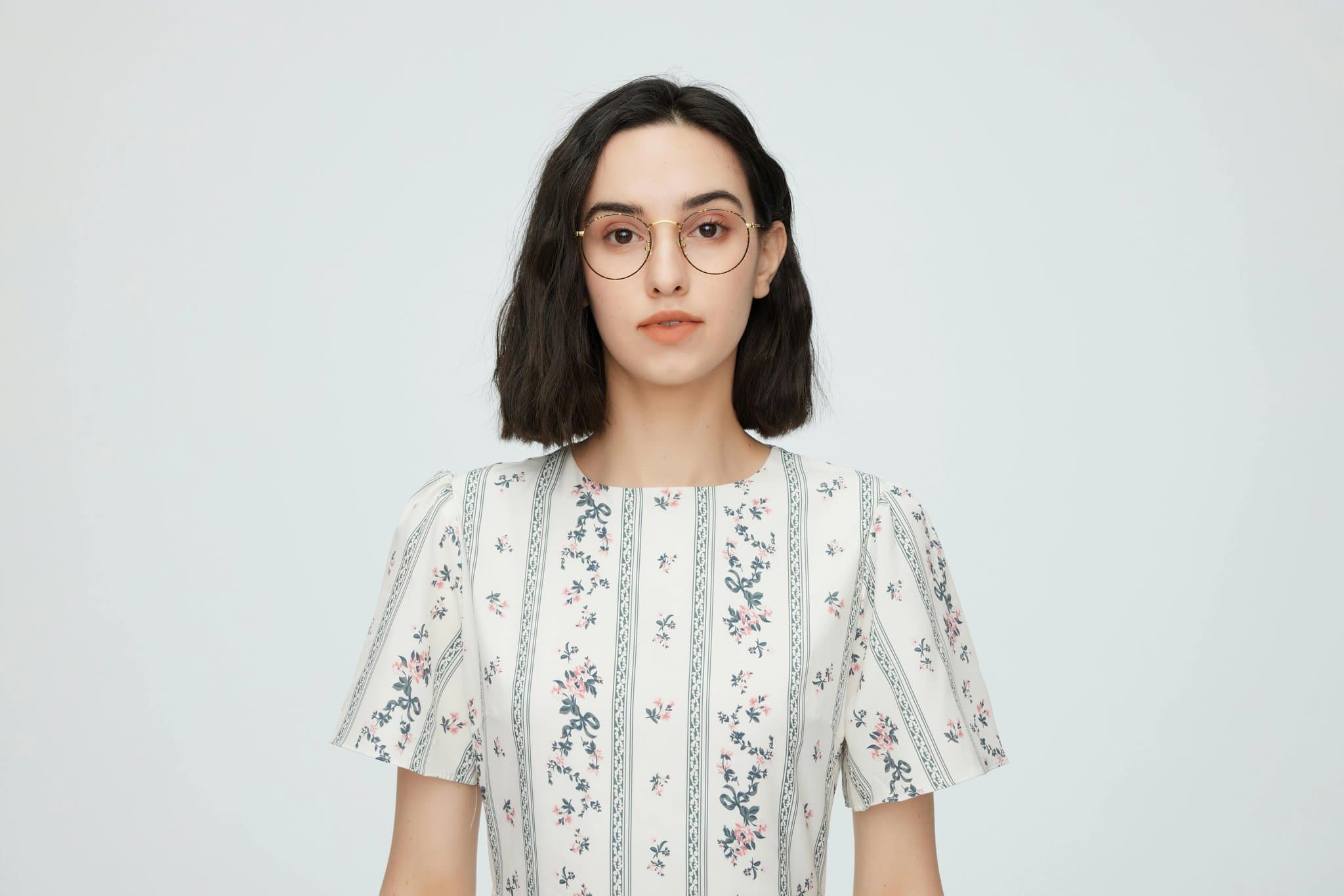 A photo of a girl wearing a plain white dress or light colored outfit.