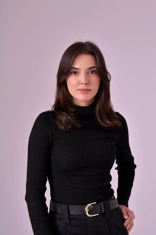 a portrait of a person edited to narrow the face by pulling both sides inward along the cheeks and jaw, concentrating the chin area without elongating it, producing a visibly slimmer and more structured face shape