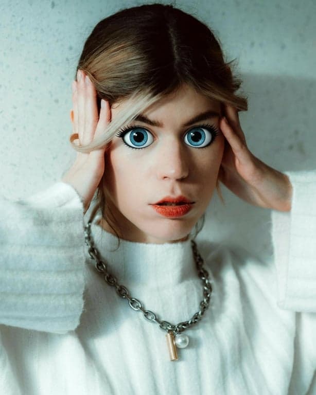 AI big eyes filter after photo - women wearing white sweater after big eyes filter