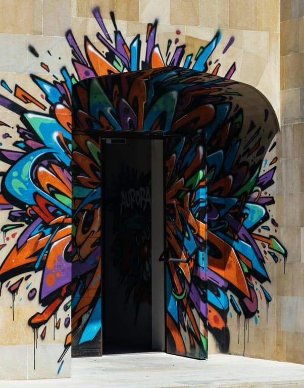 Generate a wildstyle graffiti piece built around directional movement and visual flow. Use arrows, extensions, rotations, and interlocking strokes to guide the viewer’s eye across the wall, prioritizing motion, complexity, and energy over immediate readability while maintaining intentional structure.