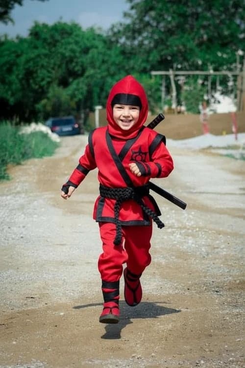 After ninja photo – child in bright red ninja costume with accessories