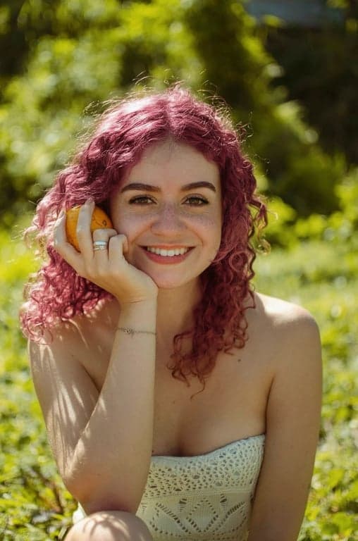 a portrait of a person enhanced with pink hair color while keeping natural texture, scalp transitions, and hairline integrity