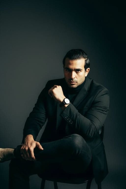 A high-quality AI portrait studio output of a man, dynamic lighting for depth, detailed hair and fabric texture, professional color correction, studio environment.