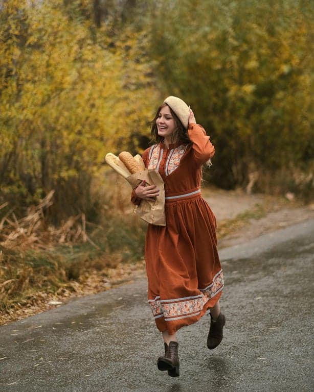A street scene transformed with an 80s film look, featuring strong grain structure, cyan shadows, and the halation effect typical of older film stocks.