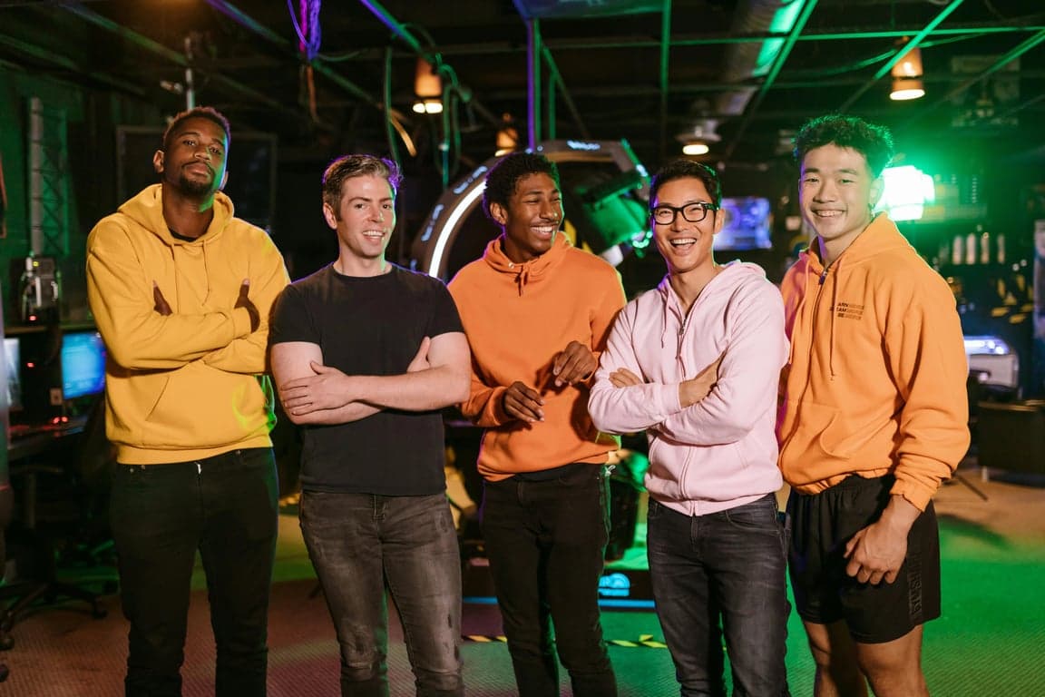 a portrait of a male group edited into a high-impact K-pop boy group look, using bold outfit pieces, layered styling, strong silhouettes, confident group pose, and clean lighting