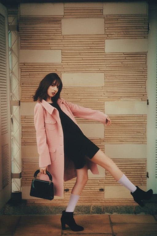 a portrait of a woman with a warm 1970s color film grain effect, featuring muted tones, soft glow, and subtle color shifts