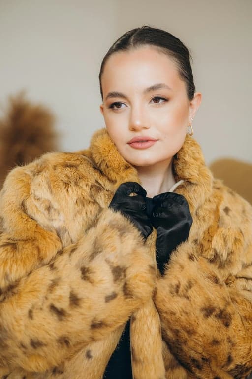 Convert the original person into a human-style Hello Kitty world sticker while preserving hairstyle and pose. Simplify facial features, exaggerate proportions, and place Hello Kitty next to the character within the same sticker frame so the shared Hello Kitty universe is immediately recognizable.