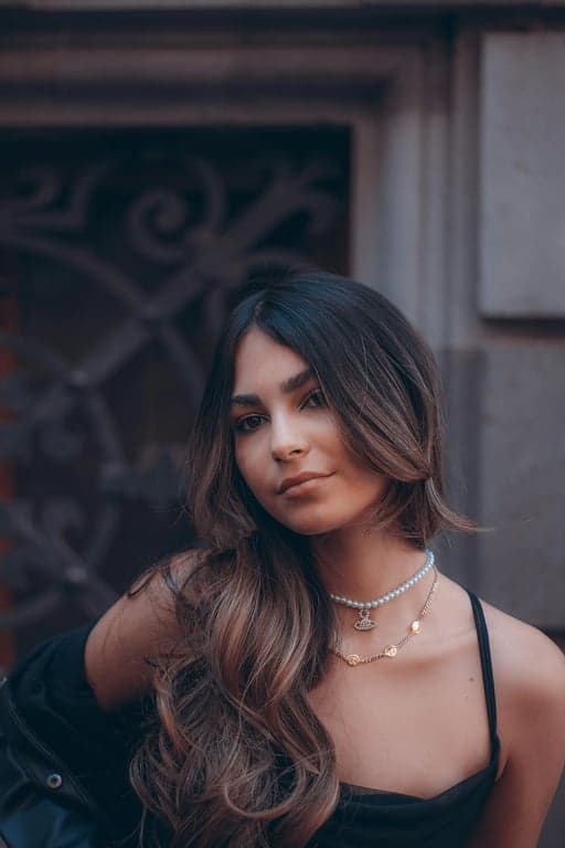 a fishtail braid with intricate sections, loosely woven for volume and texture, with natural-looking separation between the strands, and a polished finish that enhances the overall texture