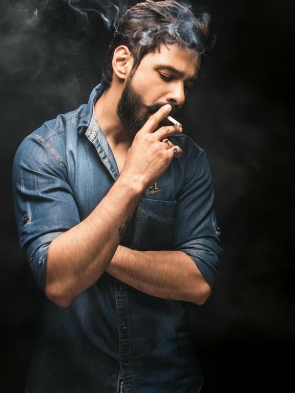 a portrait transformed with a full goatee and mustache style, where the facial hair is thick and covers the chin and upper lip completely