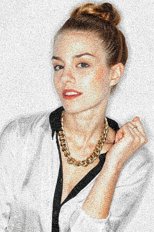 A portrait of a woman in color ASCII art, where characters (such as ^, ", ~) are colored in shades of grey, orange, and white to mimic fur patterns.