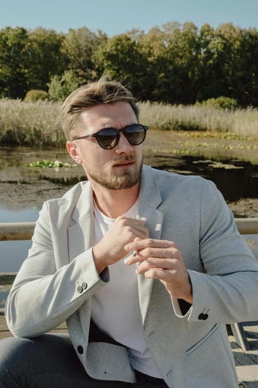 a portrait of a person reinterpreted in a Japanese anime hero art style inspired by My Hero Academia, with sharp linework, stylized facial proportions, dramatic highlights, and a minimal anime gradient background