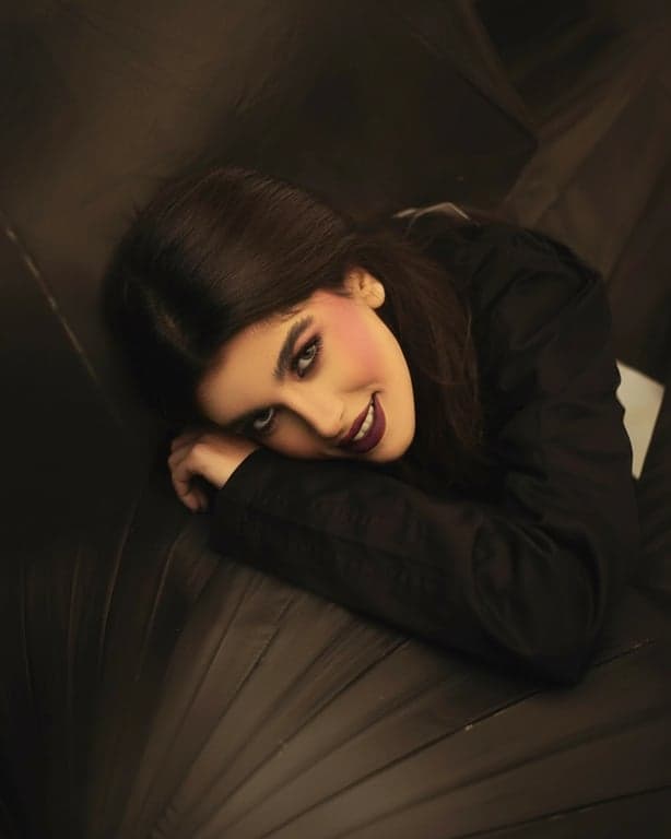 a portrait of a person edited with sunset-inspired lighting, including warm highlights, gentle contrast reduction, neutral shadows, and natural skin tone preservation