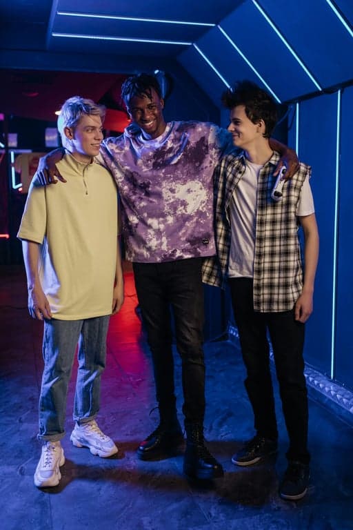 a portrait of multiple men transformed into a balanced K-pop boy group fashion set, with tailored proportions, cohesive styling direction, visible garment structure, neutral background, and professional idol presentation