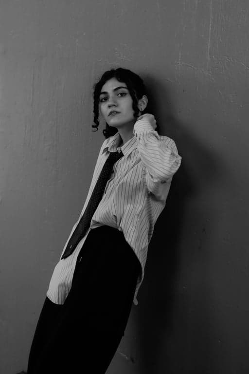 a portrait of a person transformed with a refined T-shirt design presentation featuring a single flat illustration placed inside a rectangular print area on the chest, limited color palette, no texture or pattern fill, clean borders, accurate fabric interaction, consistent lighting, and natural body posture