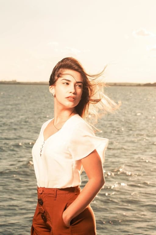 a portrait of a person rendered in a contemporary Indigenous art style featuring clean modern linework, stylized facial detail, symbolic pattern accents, controlled color palette, flat lighting, and a respectful modern Native American visual identity