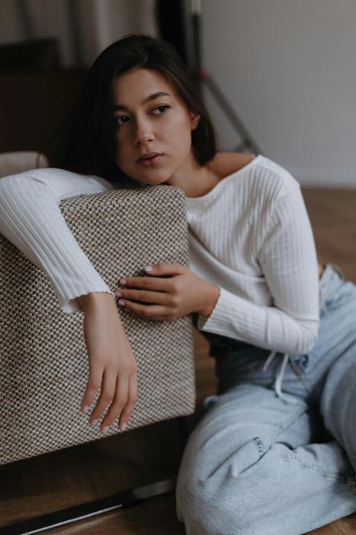 a portrait of a person styled with clean fashion aesthetics, simple yet polished outfit, relaxed posture, even lighting, and minimal background
