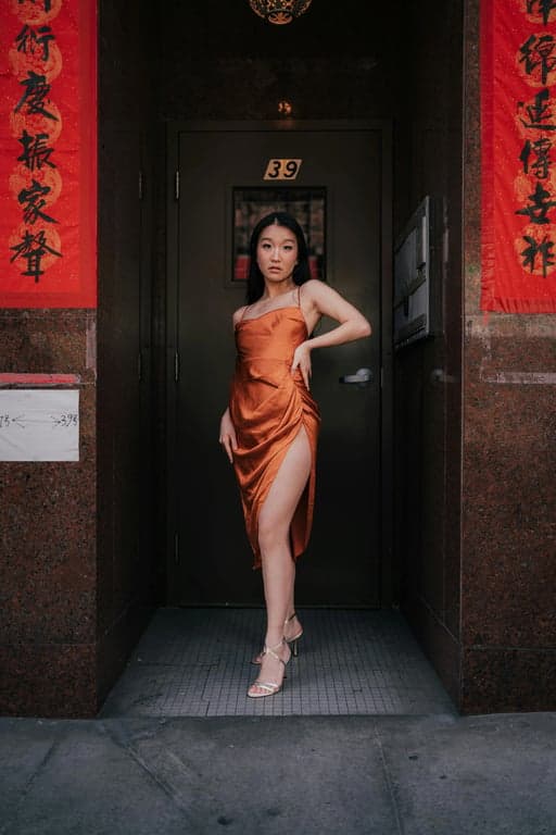 a portrait of a pregnant woman transformed into a sleek black maternity swimsuit, posing against a minimalist white backdrop