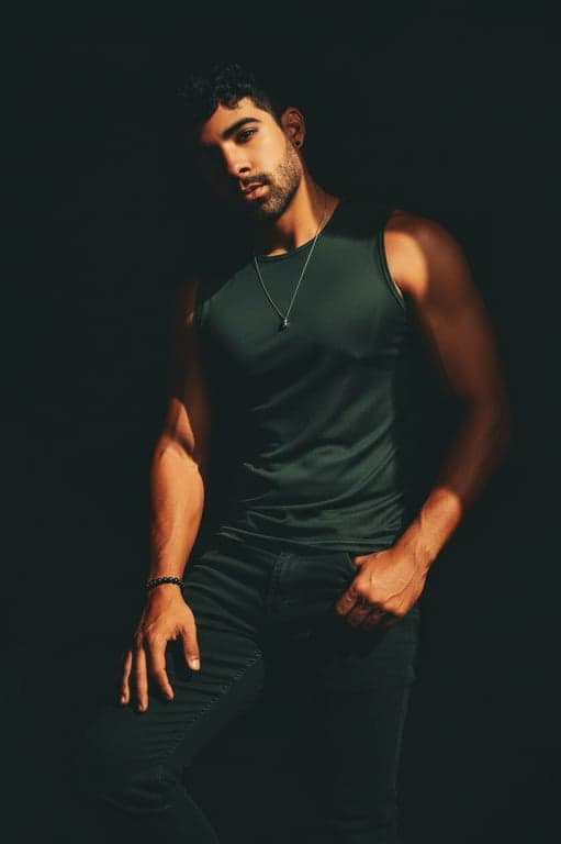 Extend the original portrait into a professional full-body image by reconstructing the lower body only. Preserve the same attire, background, and professional tone, and complete the stance with upright posture, balanced body proportions, and clean lighting continuity without introducing new styling elements.