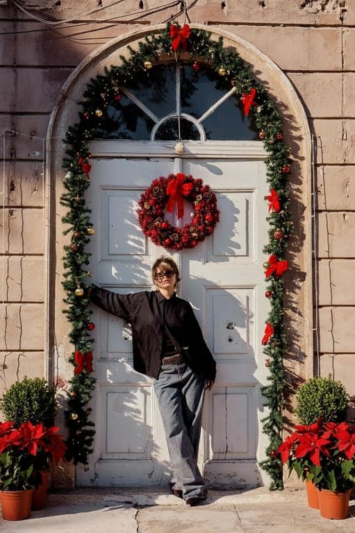 AI Christmas background free after photo - woman wearing black jacket with Christmas background