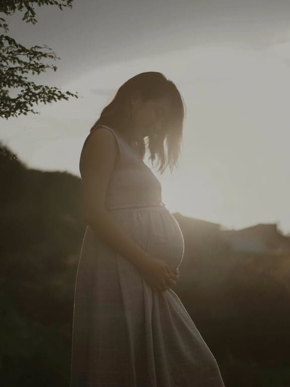 a portrait of a person edited to maintain original facial illumination, eliminating distracting light streaks and flare artifacts without affecting natural light and shadow structure