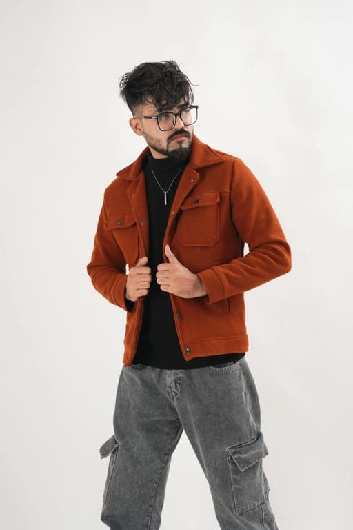 a portrait of a man edited in a Korean two-block men hairstyle style, so that the top hair is medium length and straight and visibly longer than the sides, with the fringe extending over the forehead in a typical Korean haircut silhouette, sides and back cut much shorter, no curls or waves, and unchanged face and original lighting