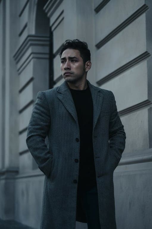 a portrait of a man, emotional sad edit, watery eyes, downturned mouth, cool desaturated color grade, dramatic shadows.