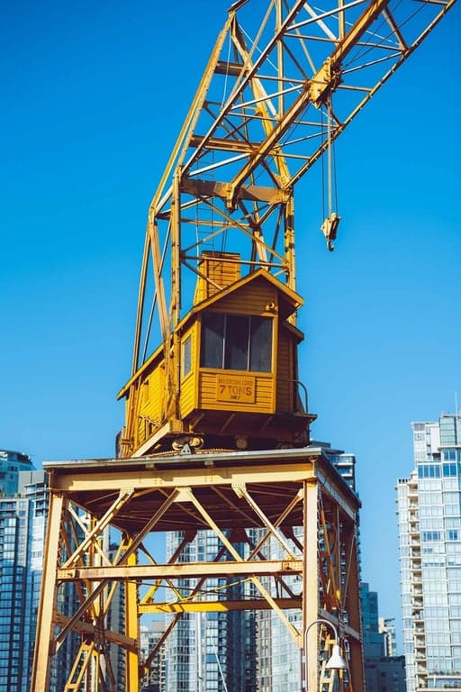 a simple drawing of a house and sun, crayon art style, thick uneven lines, scribbled coloring outside lines, paper texture background.