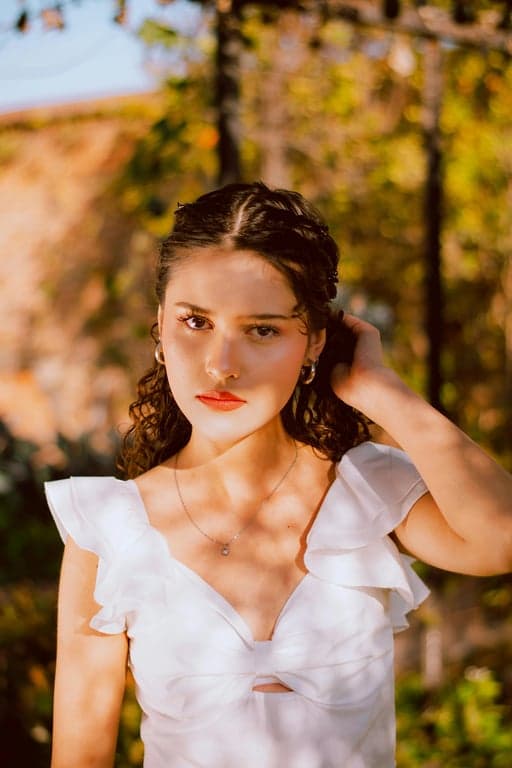 a portrait of a person transformed into a Jujutsu Kaisen–inspired anime illustration with clean sharp outlines, muted cool color palette, intense gaze, modern anime clothing, and dark atmospheric lighting