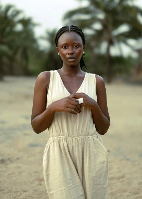 a portrait of a person enhanced with a Polaroid instant photo look, featuring soft contrast, slightly faded colors, warm highlights, gentle haze, subtle vignetting, and clean instant-film texture