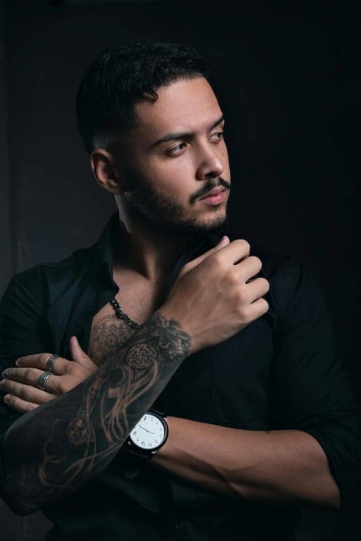 a portrait of a person rendered in a cinematic anime hero style, emphasizing dramatic light-shadow contrast, confident expression, anime costume design, and clean manga-inspired visuals