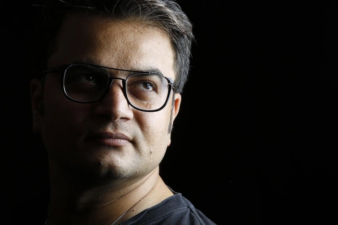 ai remove glasses from photo before photo - man portrait with black background